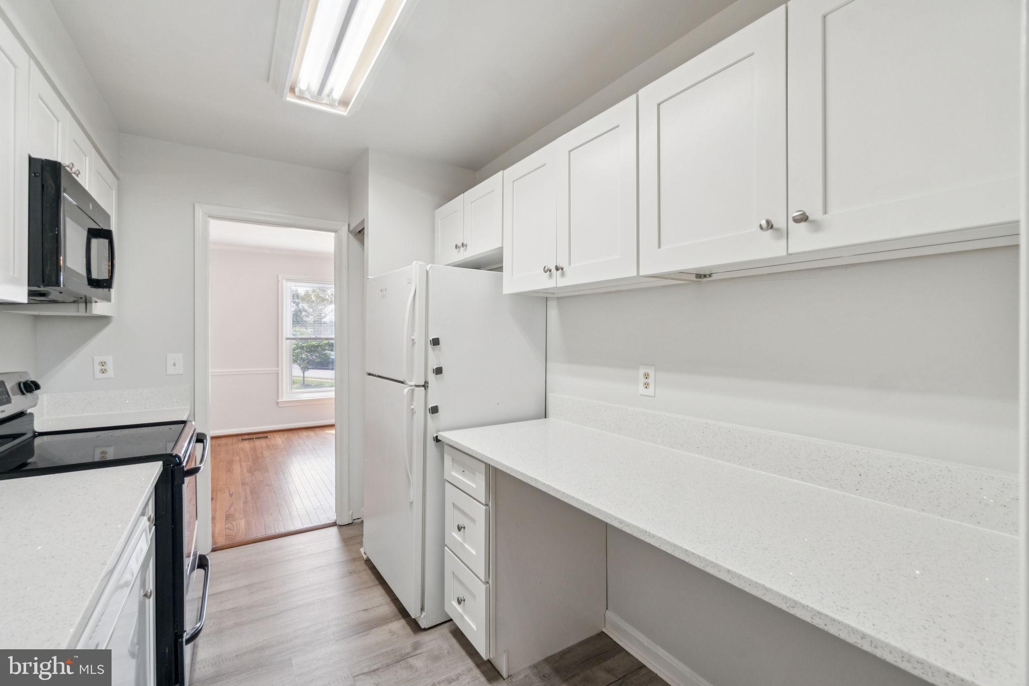 6711 Washington Boulevard, Unit C Arlington, VA 22205 - Photo 4 of 30 a kitchen with cabinets and a refrigerator