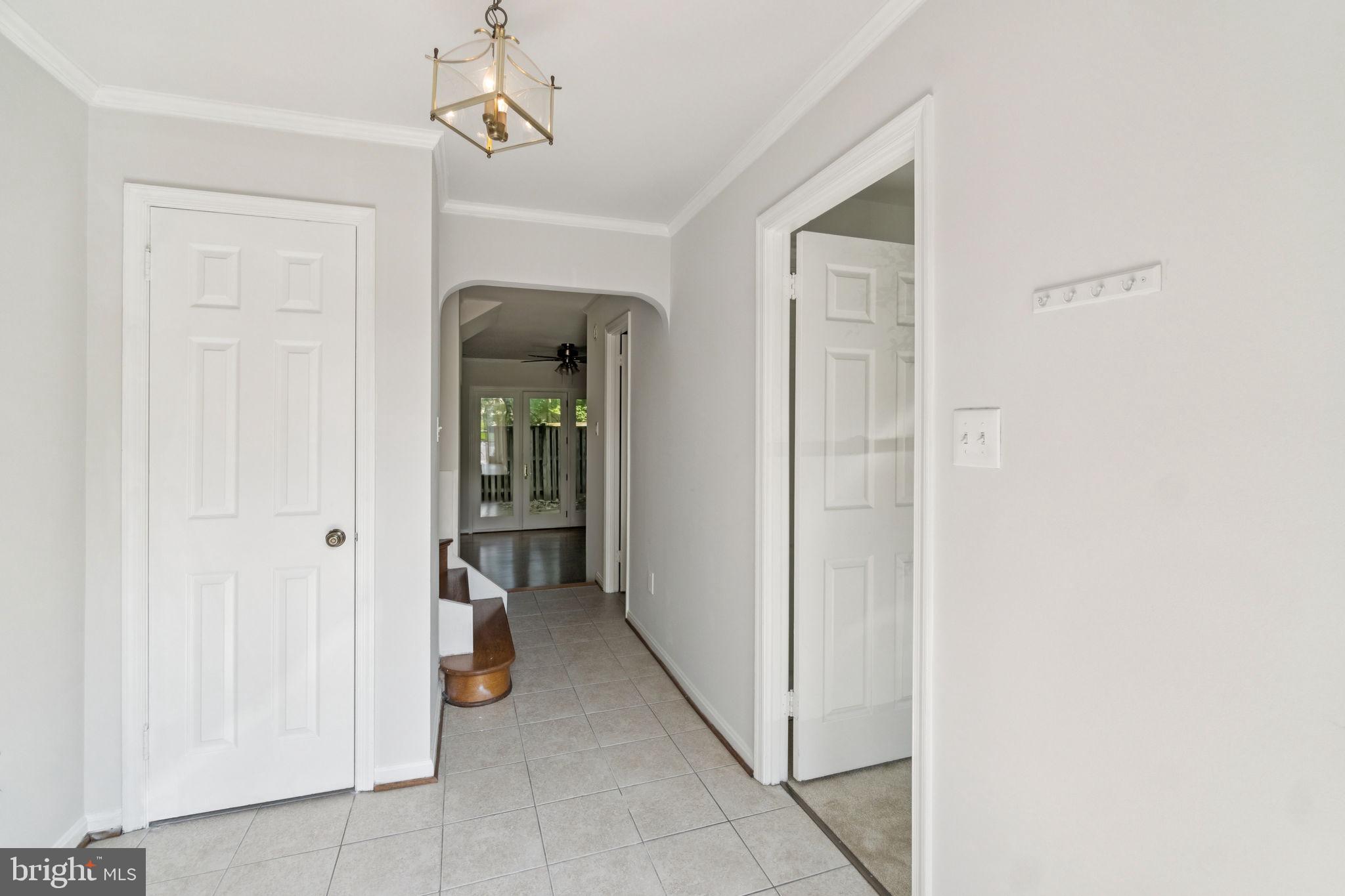6711 Washington Boulevard, Unit C Arlington, VA 22205 - Photo 5 of 30 a view of a hallway to closet and a mirror