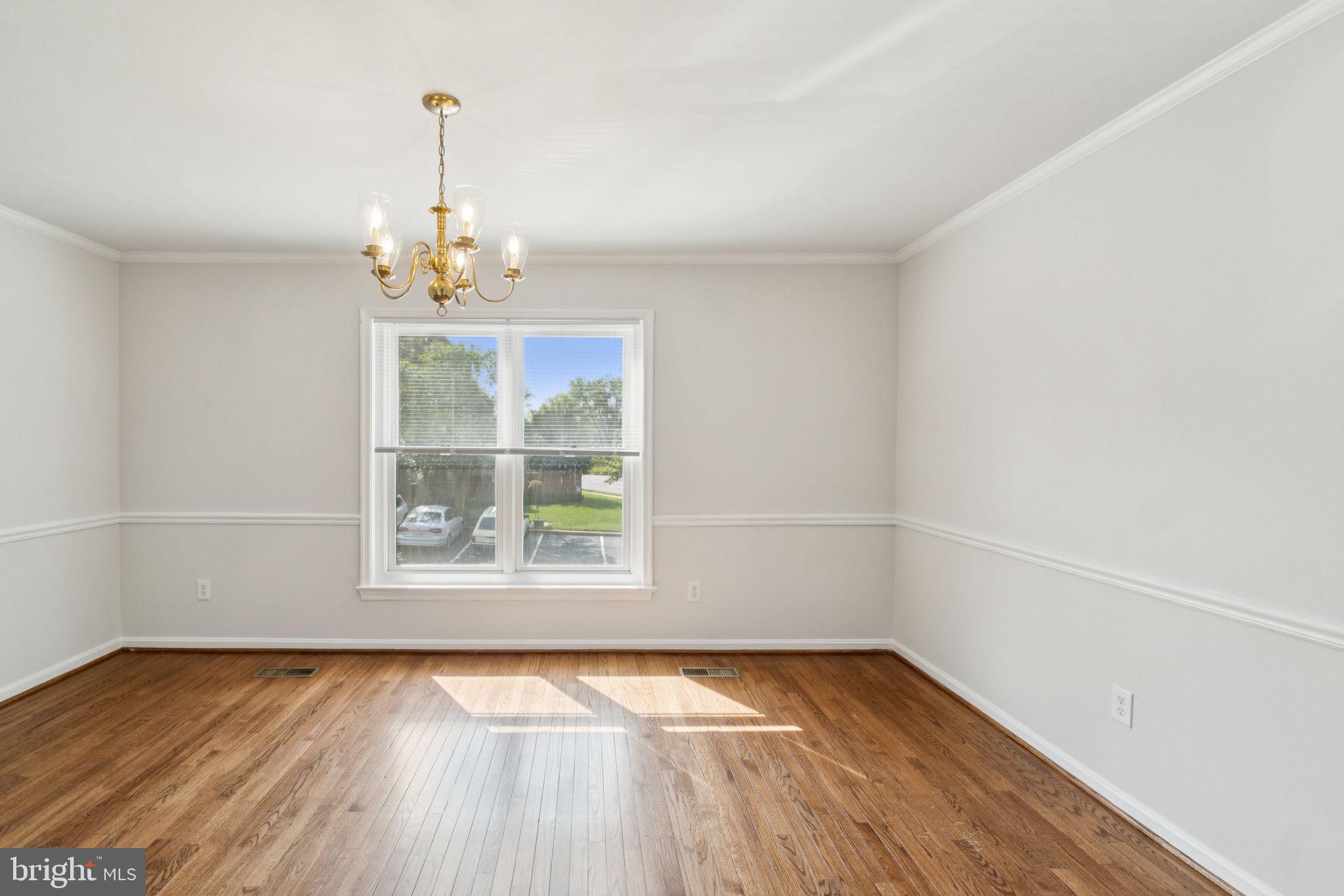 6711 Washington Boulevard, Unit C Arlington, VA 22205 - Photo 10 of 30 wooden floor in an empty room with a window