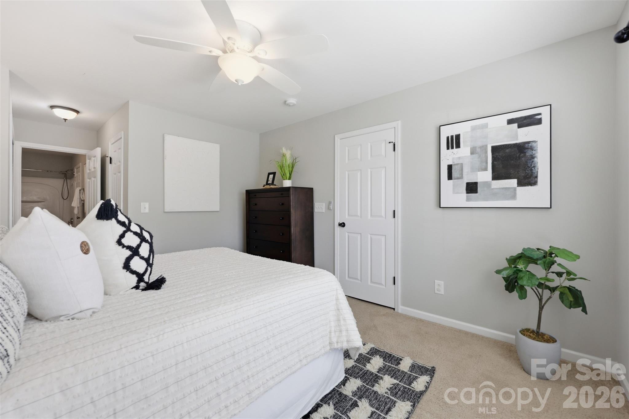 212 Primrose Walk Fort Mill, SC 29715 - Photo 16 of 37 a bedroom with a bed and a chandelier
