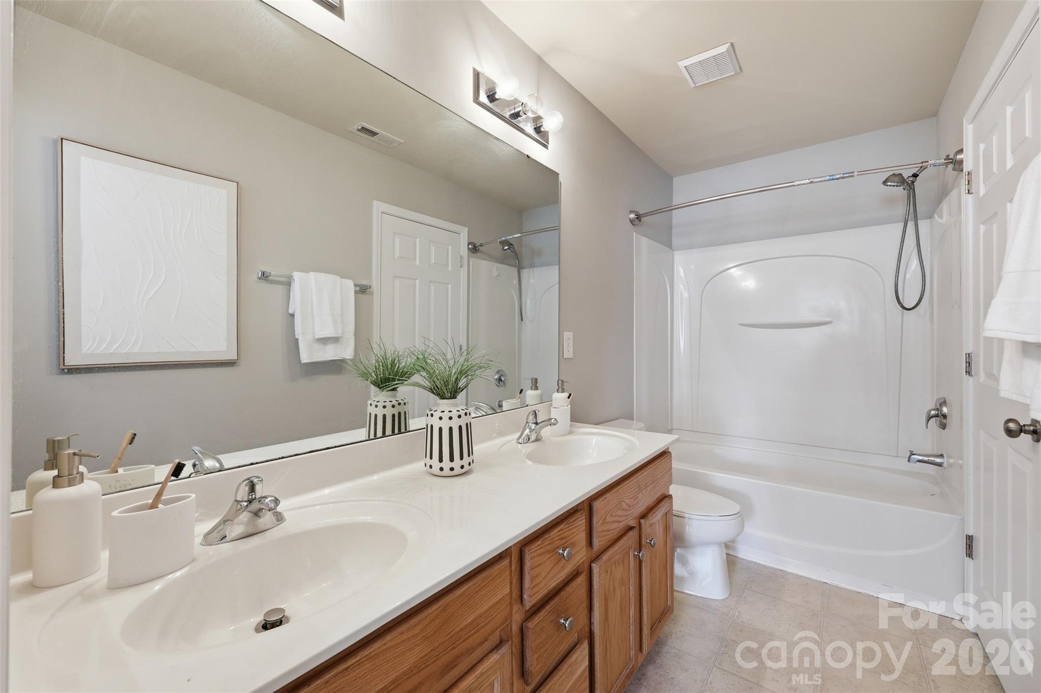 212 Primrose Walk Fort Mill, SC 29715 - Photo 17 of 37 a bathroom with a double vanity sink mirror double and bathtub