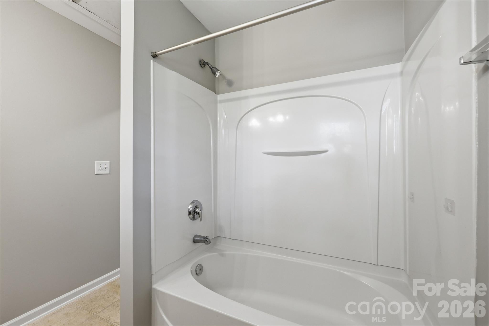 212 Primrose Walk Fort Mill, SC 29715 - Photo 24 of 37 a white bath tub sitting next to a shower