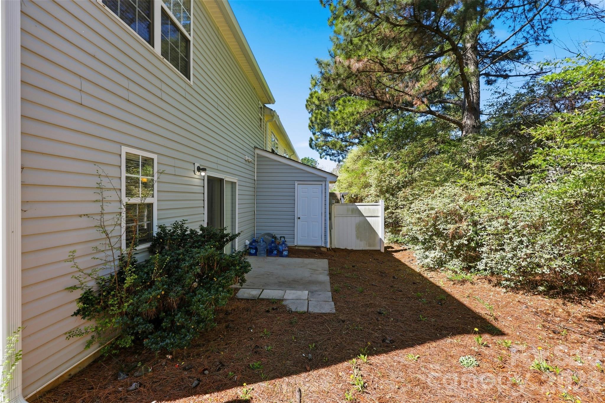 212 Primrose Walk Fort Mill, SC 29715 - Photo 26 of 37 a view of backyard with potted plants and wooden fence