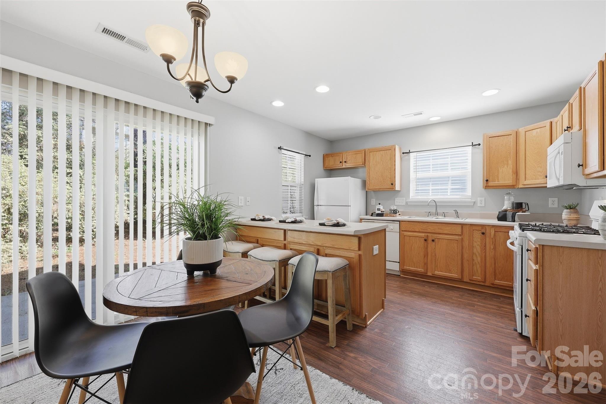 212 Primrose Walk Fort Mill, SC 29715 - Photo 8 of 37 a kitchen with a table chairs sink and cabinets
