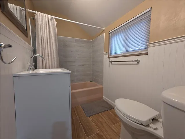 a bathroom with a toilet a sink and bathtub