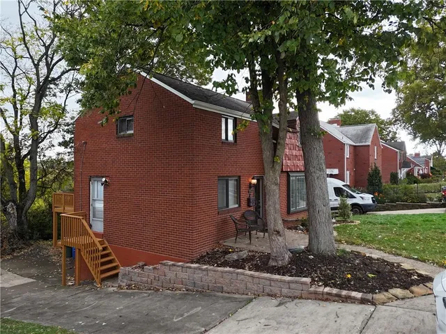 a backyard of a house with barbeque oven