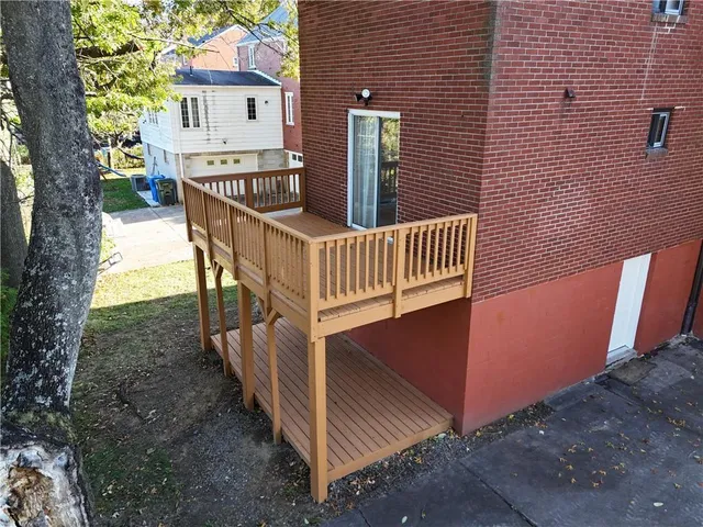 a view of a house with wooden fence and a porch