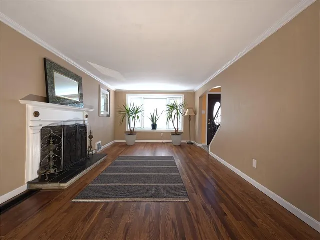 a view of livingroom with fireplace wooden floor and window