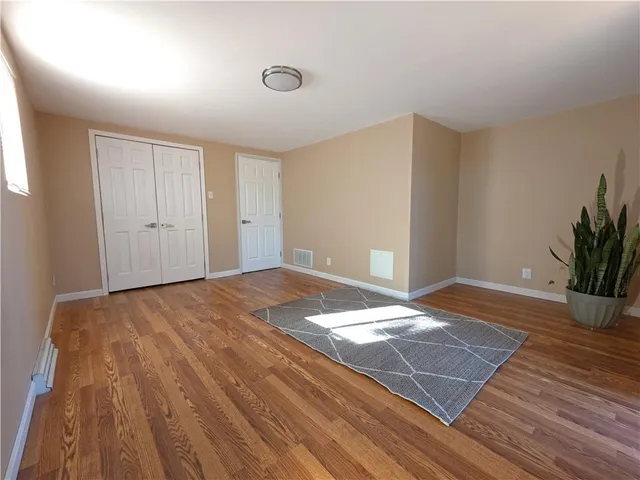 a view of a livingroom with wooden floor and closet area