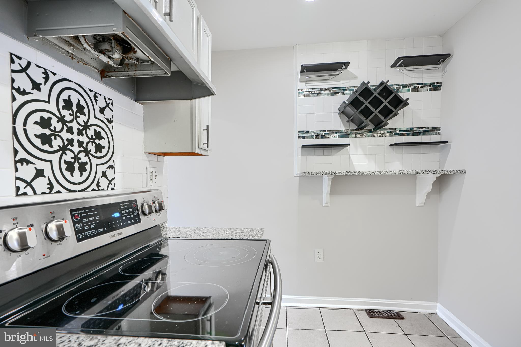 1127 Sargeant Street Baltimore, MD 21223 - Photo 12 of 30 a kitchen with a stove and a microwave