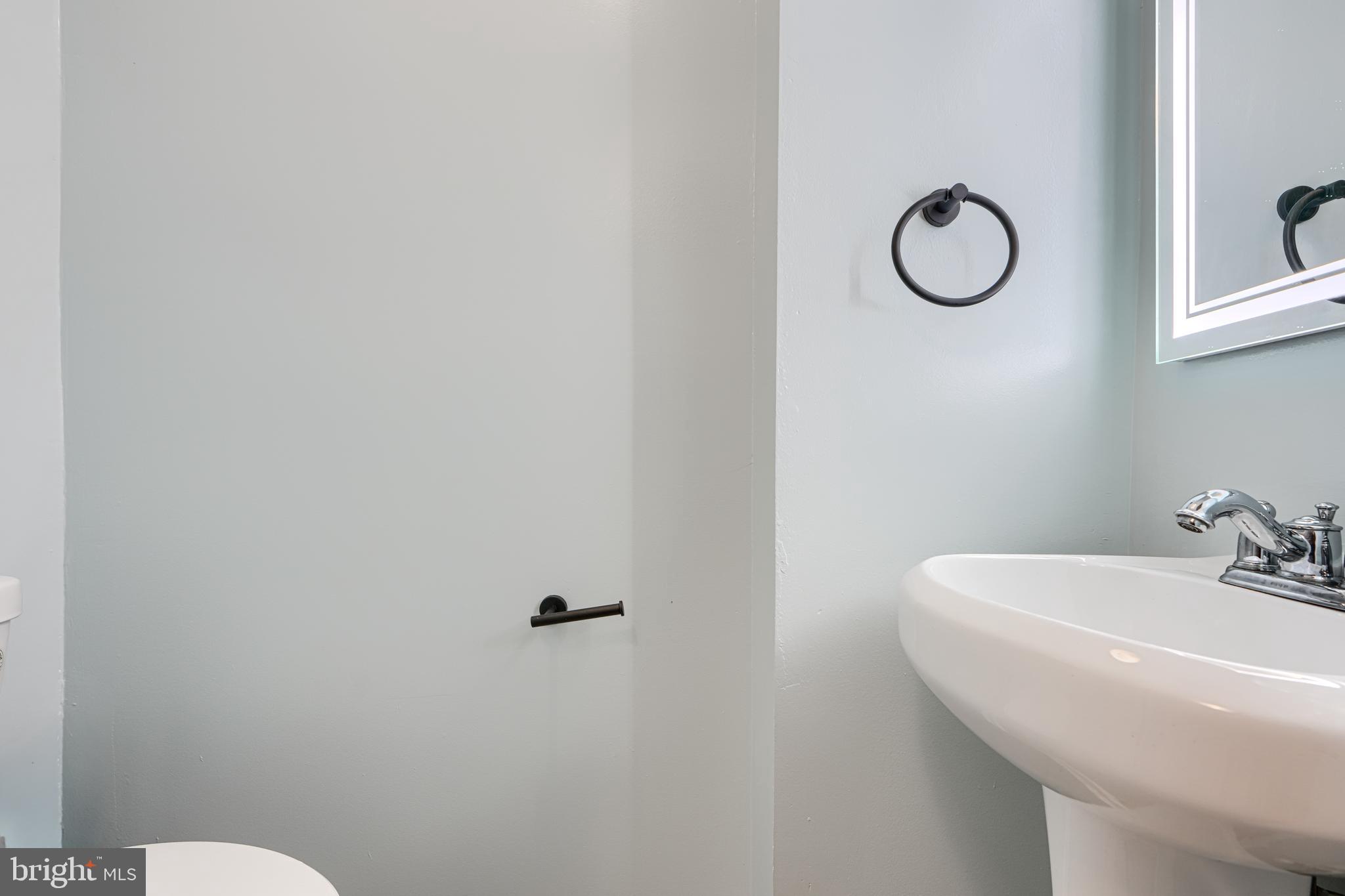 1127 Sargeant Street Baltimore, MD 21223 - Photo 15 of 30 a bathroom with a sink and a toilet