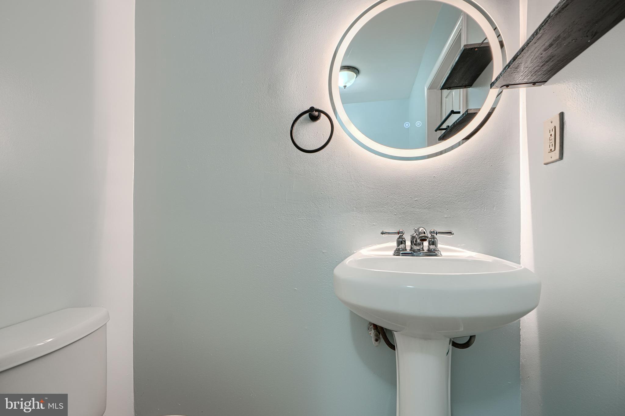 1127 Sargeant Street Baltimore, MD 21223 - Photo 23 of 30 a bathroom with a sink and mirror