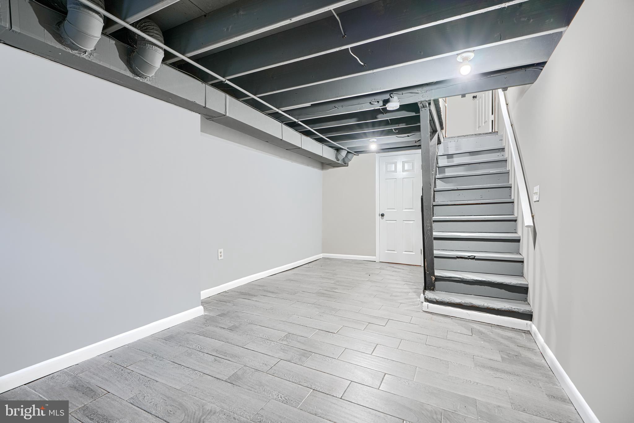 1127 Sargeant Street Baltimore, MD 21223 - Photo 24 of 30 a view of a room with stairs and a white door