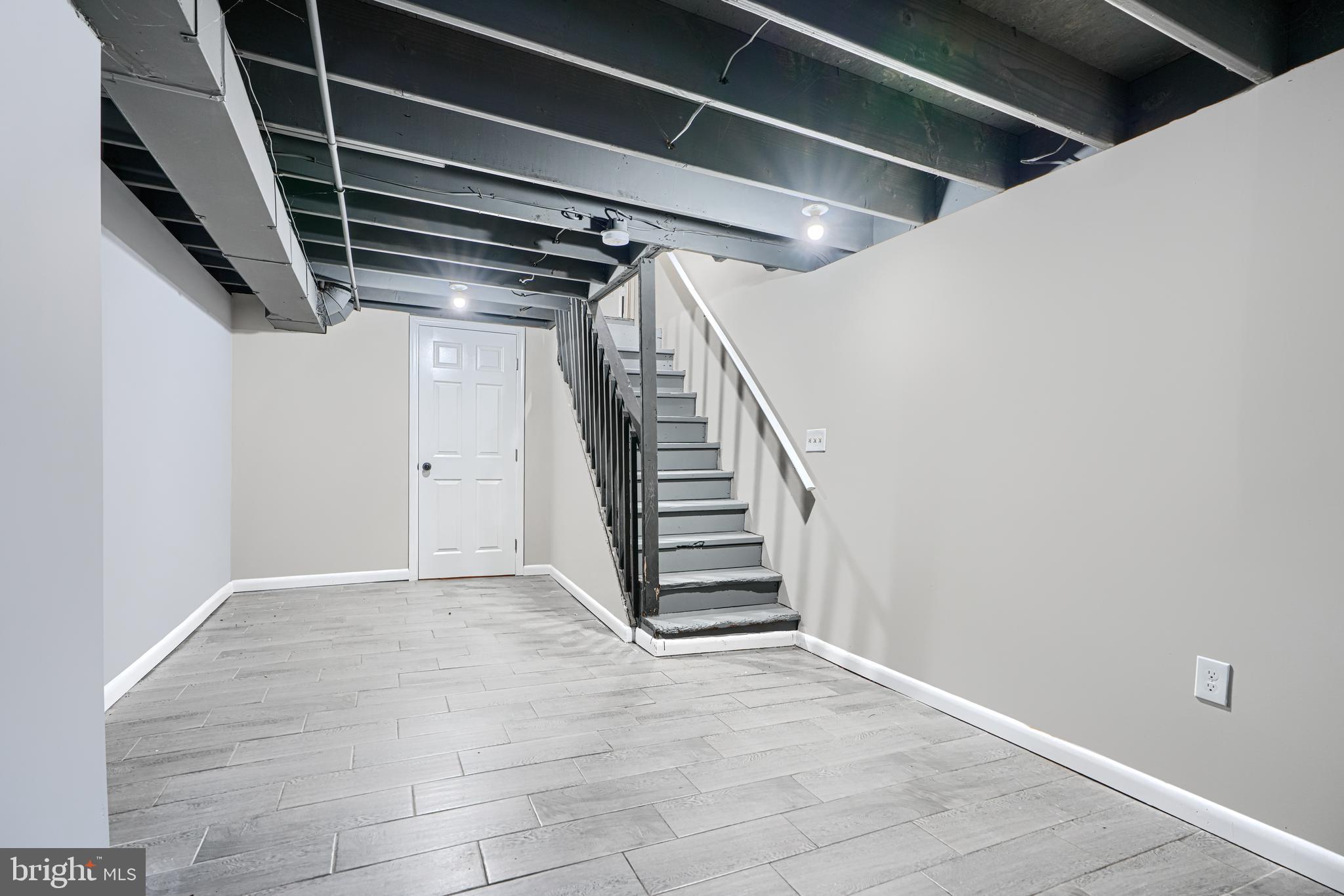 1127 Sargeant Street Baltimore, MD 21223 - Photo 25 of 30 a view of an empty room with stairs