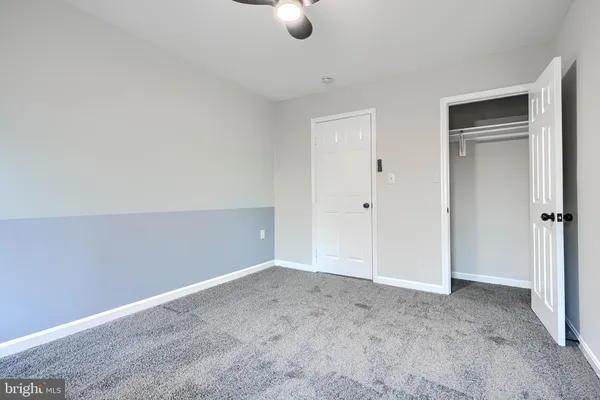 a view of a room with stairs and a white door