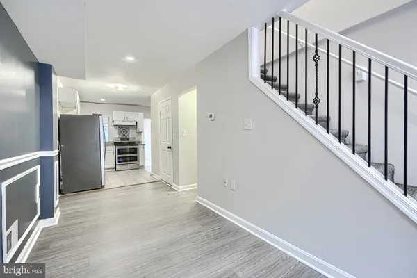 a view of a hallway with wooden floor