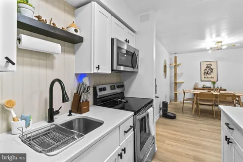 a kitchen with a stove a sink and a refrigerator