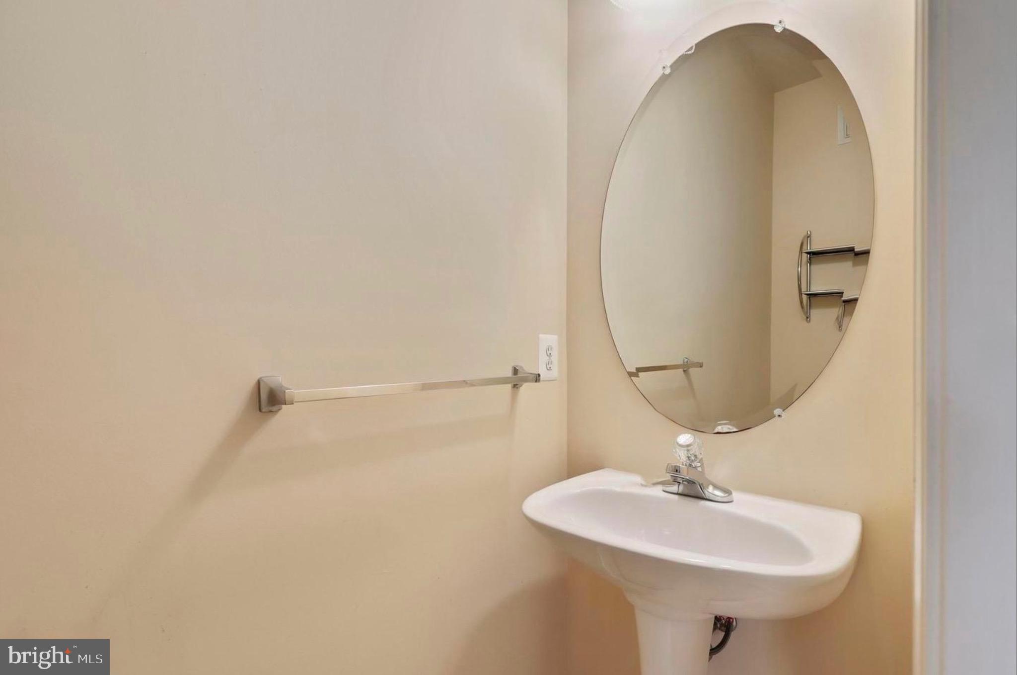 680 Orchard Ridge Drive, Unit 100 Gaithersburg, MD 20878 - Photo 7 of 25 a bathroom with a sink a mirror and vanity
