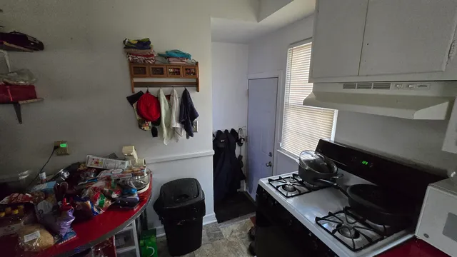 a kitchen with a refrigerator and a stove