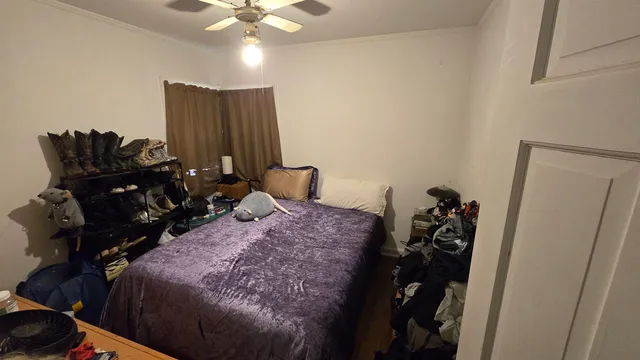 a bed room with a bed and a television