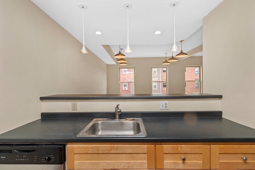 296 Meridian Street, Unit 2 Boston, MA 02128 - Photo 4 of 11 a kitchen with a sink cabinets and window