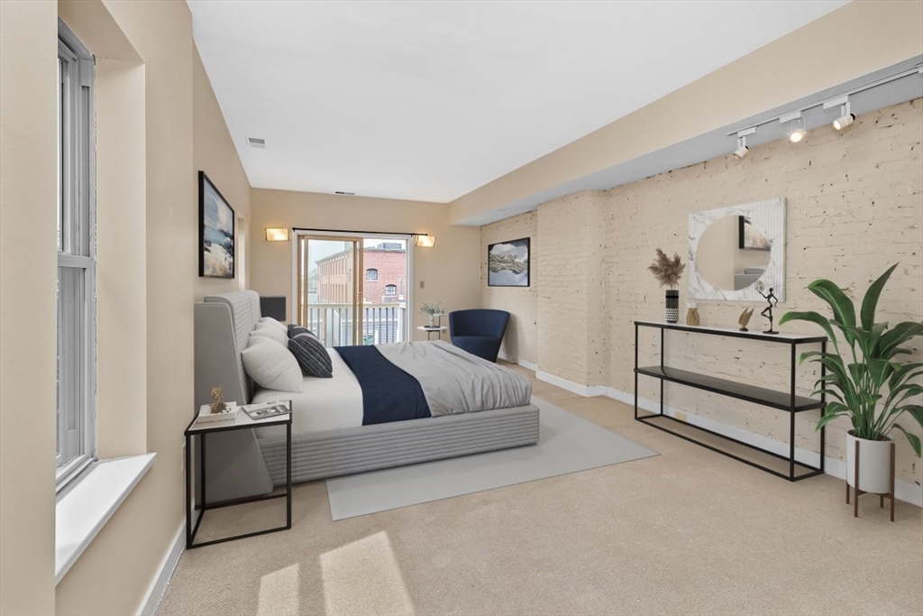 296 Meridian Street, Unit 2 Boston, MA 02128 - Photo 7 of 11 a bedroom with a large bed and a couch