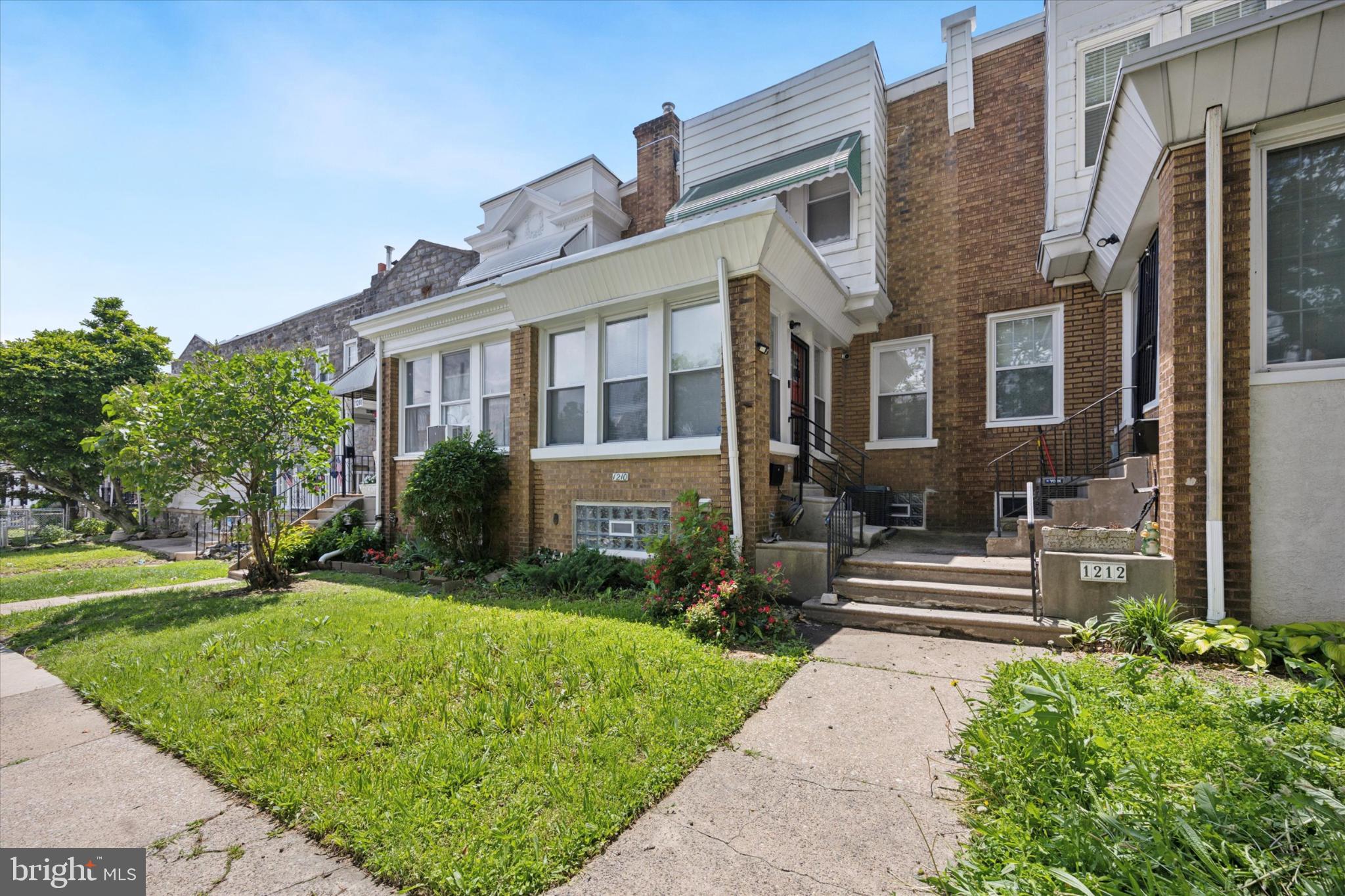 1210 Atwood Road Philadelphia, PA 19151 - Photo 23 of 25 Charming brick facade with lush greenery.