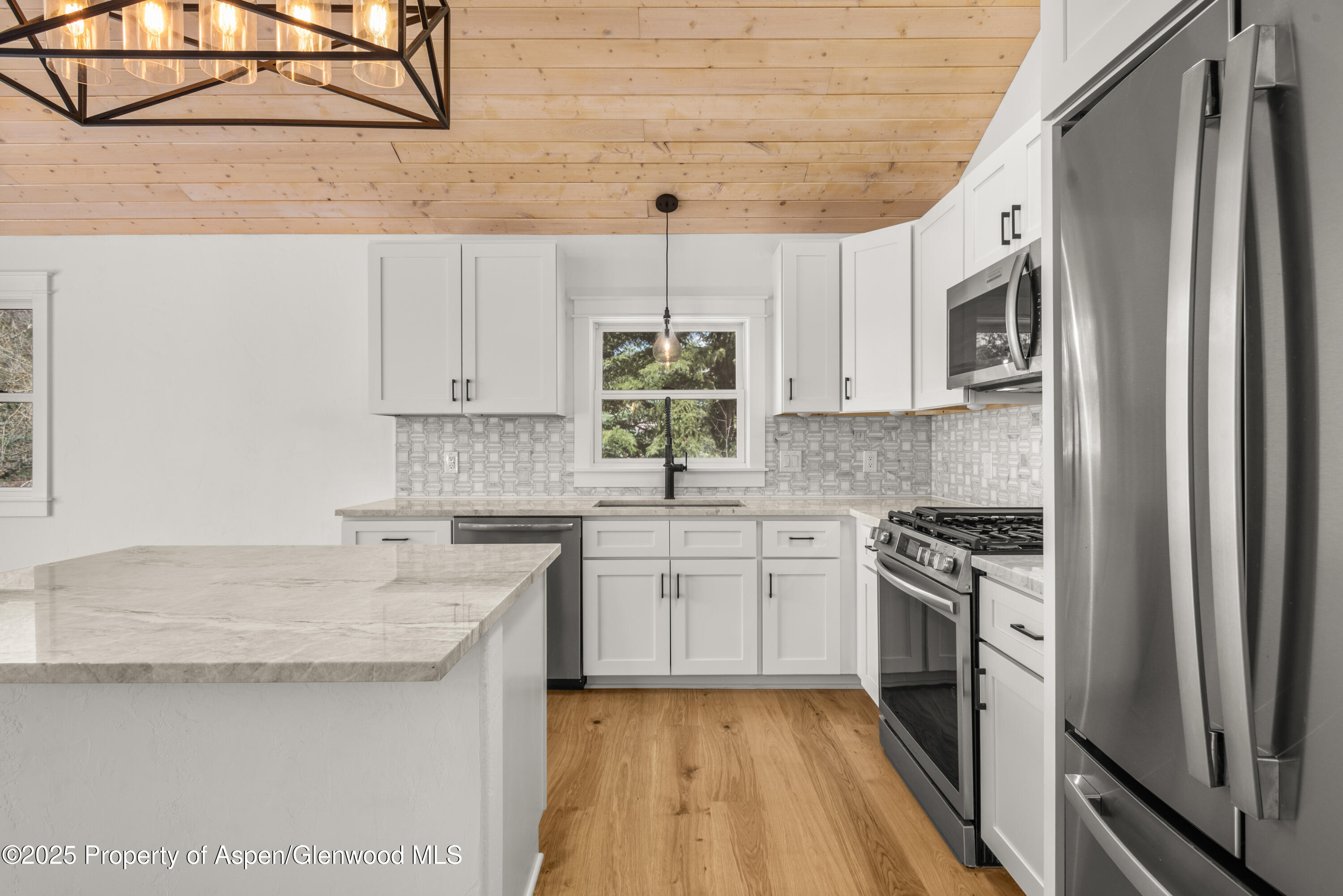 479 Redstone Boulevard Redstone, CO 81623 - Photo 7 of 26 a kitchen with stainless steel appliances granite countertop a sink stove and refrigerator