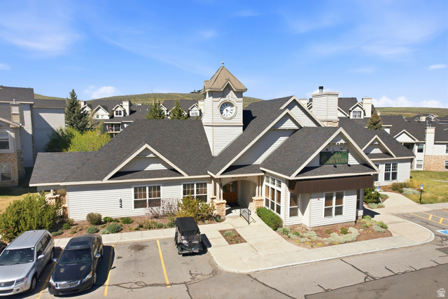 900 Bitner Road, Unit P20 Park City, UT 84098 - Photo 30 of 42 Central building featuring horizontal siding, a prominent clock tower, and dark shingle roofing
