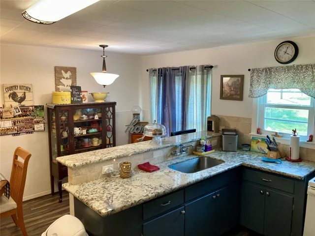 a kitchen with a table chairs and a refrigerator