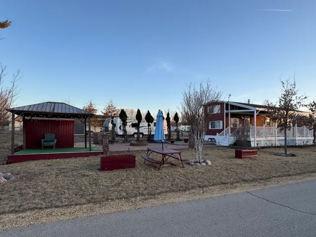 a view of a park with cars parked in front of it