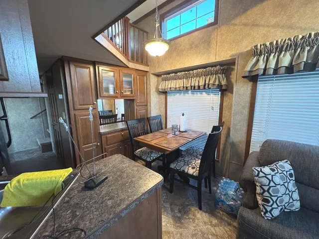 a dining room with furniture and a floor to ceiling window