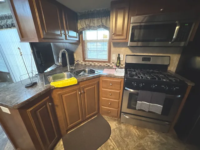 a kitchen with sink cabinets and window