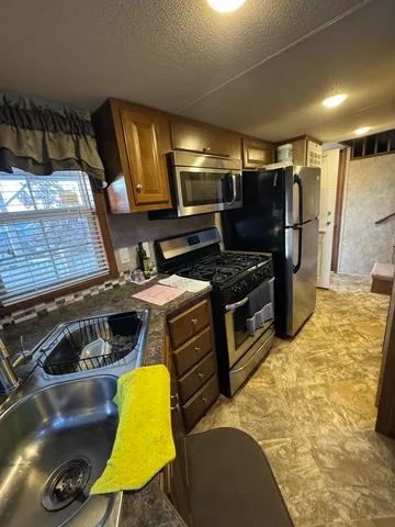 a kitchen with a stove and a refrigerator