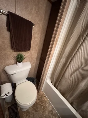 a white toilet sitting next to a window