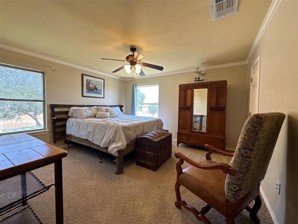 2901 Wind Mill Court Tolar, TX 76476 - Photo 14 of 38 a bedroom with a bed couch and a window