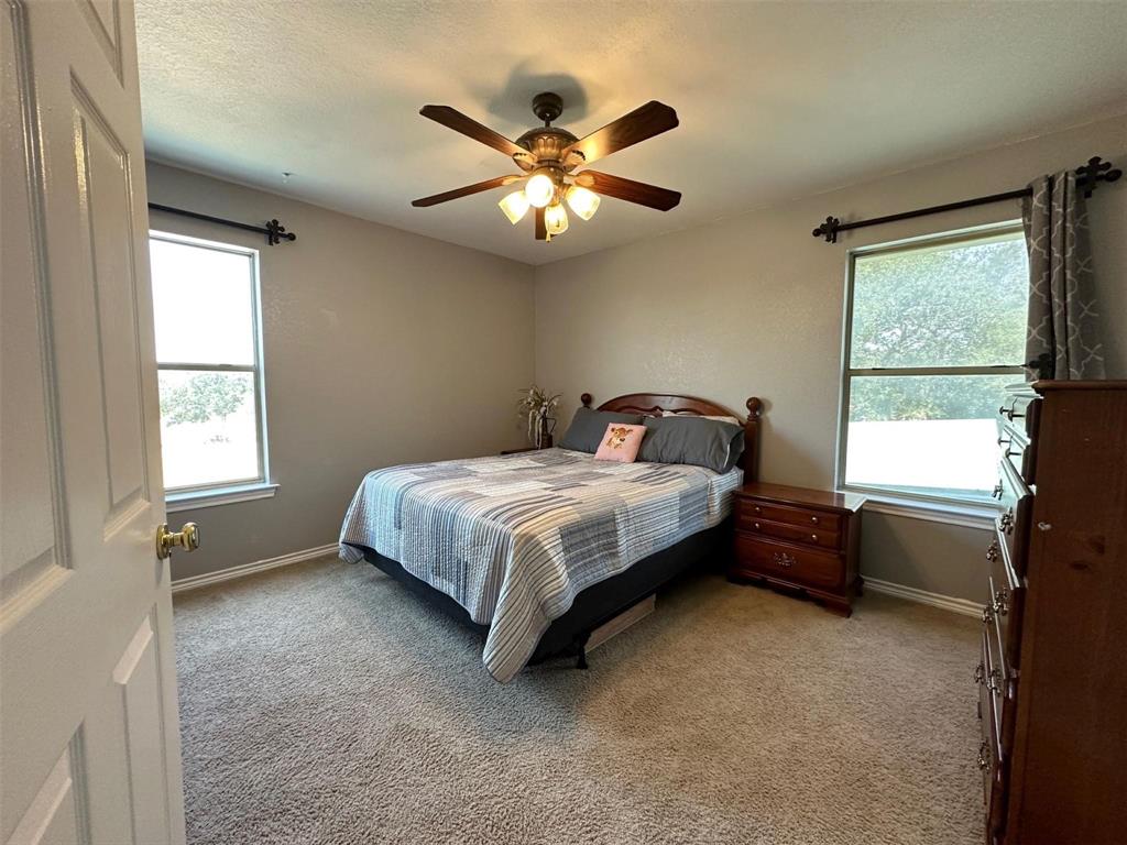 2901 Wind Mill Court Tolar, TX 76476 - Photo 15 of 38 a bedroom with a bed and window