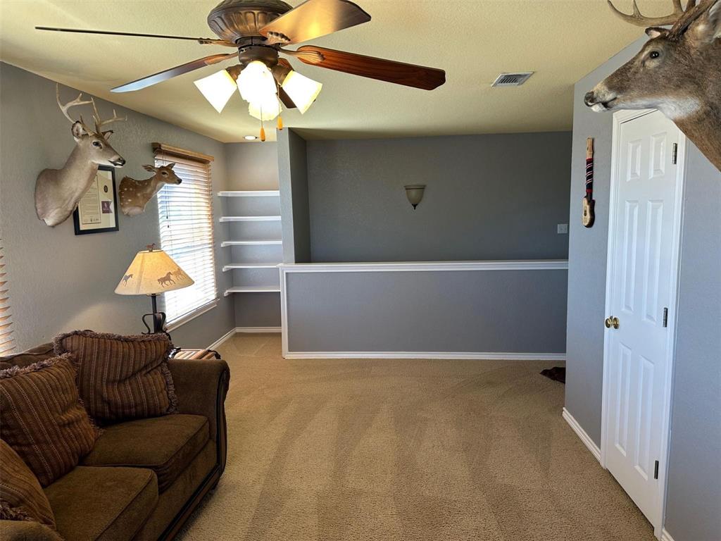 2901 Wind Mill Court Tolar, TX 76476 - Photo 18 of 38 a living room with furniture and a chandelier