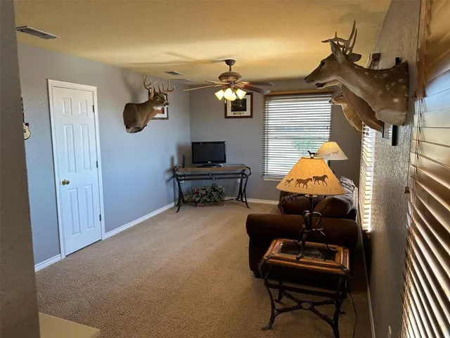 a living room filled with furniture and a chandelier