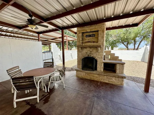 a view of a porch with furniture and a yard