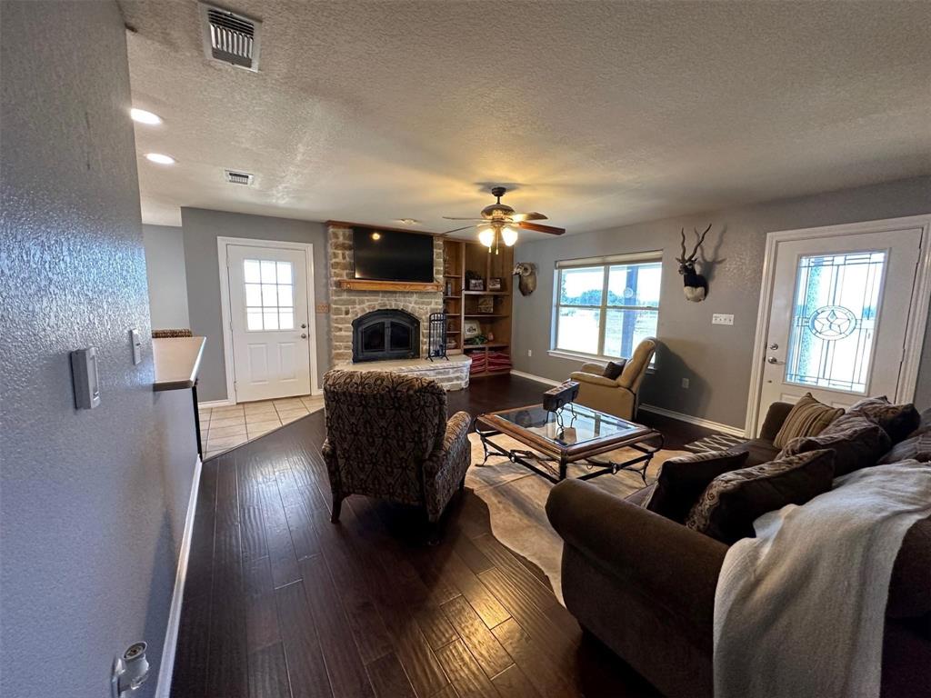 2901 Wind Mill Court Tolar, TX 76476 - Photo 5 of 38 a living room with furniture and a fireplace