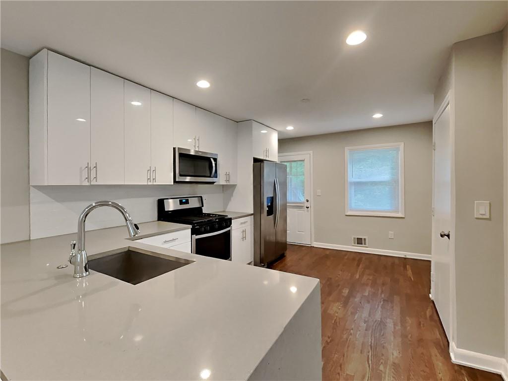 224 Buchanan Terrace Decatur, GA 30030 - Photo 12 of 23 a kitchen with stainless steel appliances a refrigerator sink and microwave