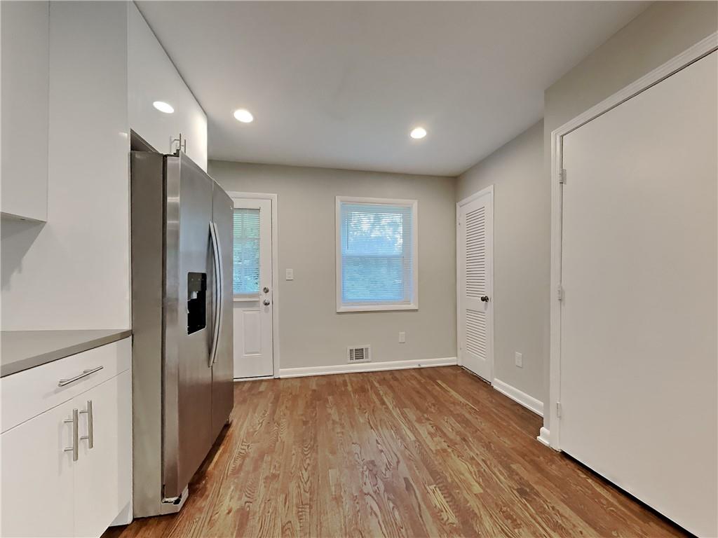 224 Buchanan Terrace Decatur, GA 30030 - Photo 13 of 23 a view of an empty room with wooden floor and a window