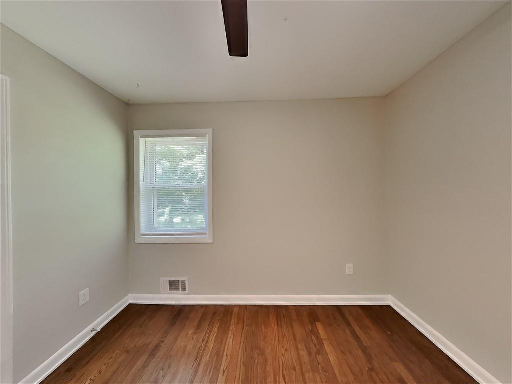 224 Buchanan Terrace Decatur, GA 30030 - Photo 16 of 23 an empty room with wooden floor and windows
