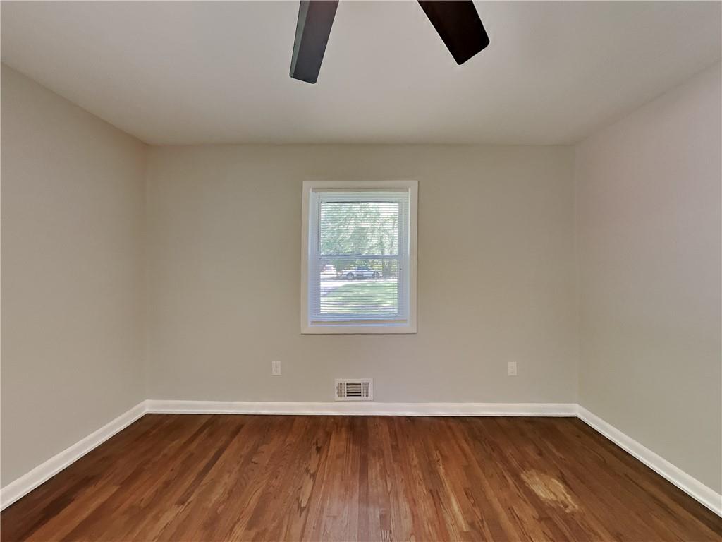 224 Buchanan Terrace Decatur, GA 30030 - Photo 17 of 23 a view of an empty room with wooden floor and a window