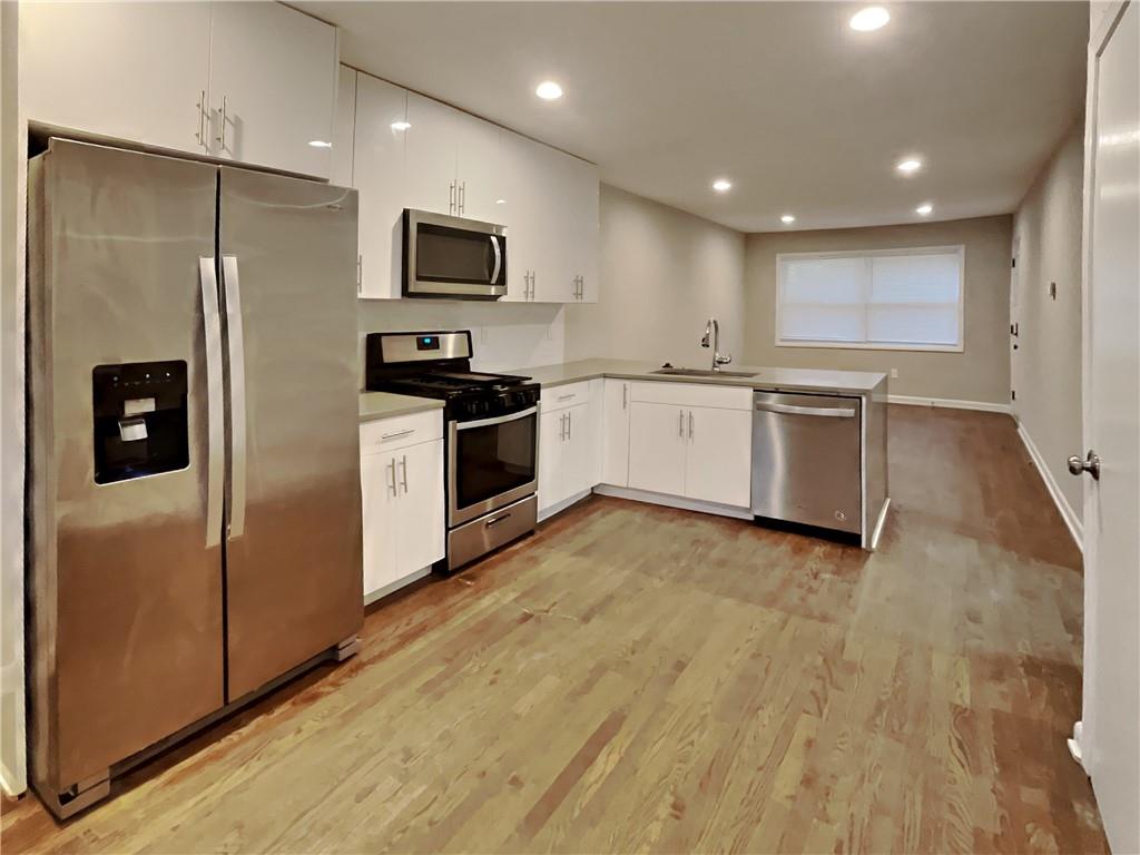 224 Buchanan Terrace Decatur, GA 30030 - Photo 5 of 23 a large kitchen with a refrigerator a stove top oven a sink and dishwasher