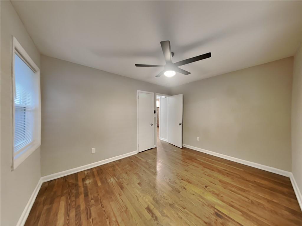 224 Buchanan Terrace Decatur, GA 30030 - Photo 6 of 23 a view of an empty room with wooden floor and a ceiling fan