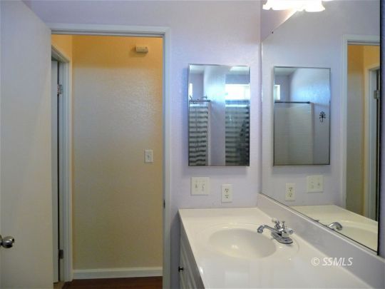 770 Alpine Way Ridgecrest, CA 93555 - Photo 43 of 50 a bathroom with a sink a shower and a mirror