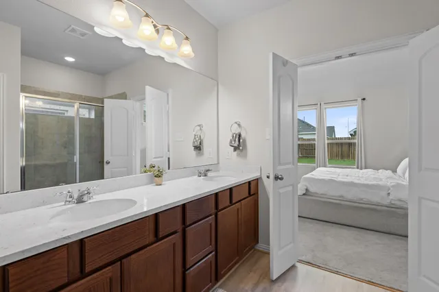a bathroom with a double vanity sink mirror and double