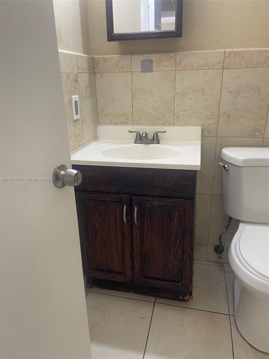 3031 Northwest 134th Street, Unit 1 Opa-Locka, FL 33054 - Photo 5 of 8 a bathroom with a sink and a toilet